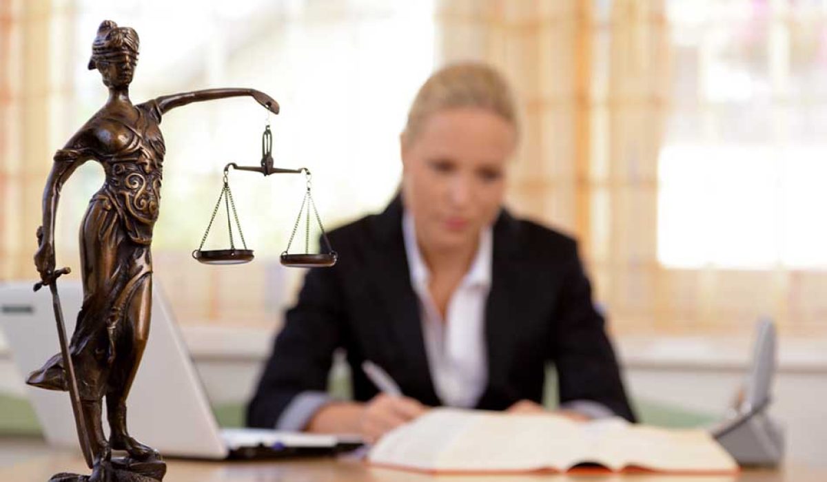a young lawyer is sitting at her desk in the office