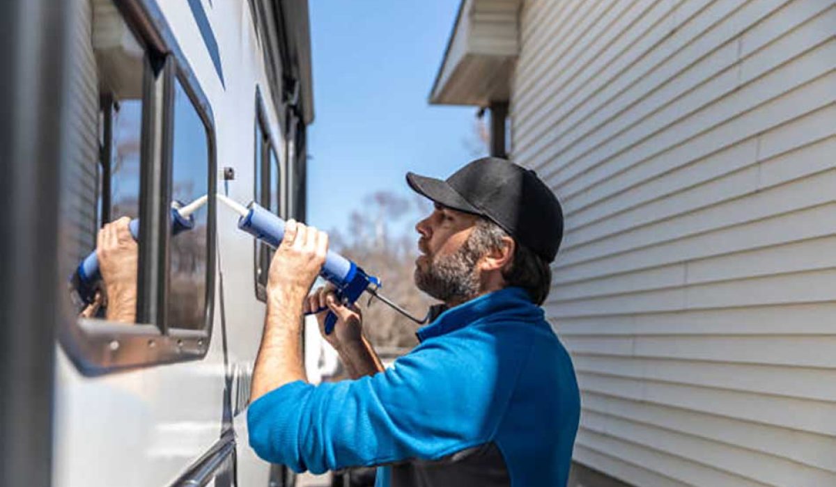Aman is doing the maintenance of a camper trailer. He is applying a sealant around the windows and other parts of the trailer. The seasonal maintenance of a travel trailer, a caravan, a motor home or a camper trailer is very important to enjoy the camping season. He is keeping himself busy during the Covid-19 pandemic.